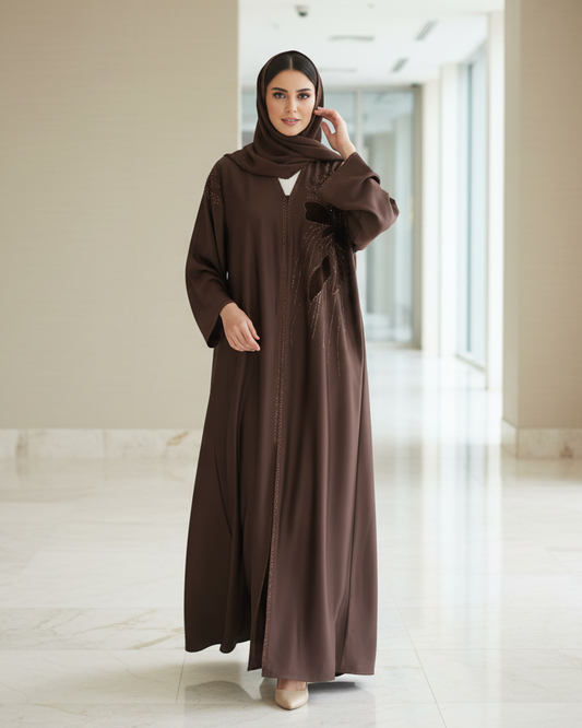 Woman wearing a brown abaya in a modern building interior