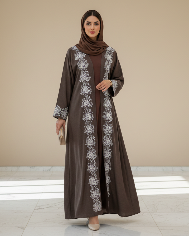 Woman wearing a brown dress with white floral patterns in a minimalistic setting